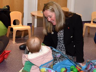 Councillor Nova Charlton with a child at one of the borough's family hubs