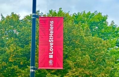 A Love St Helens banner on a lamppost with a tree in the background