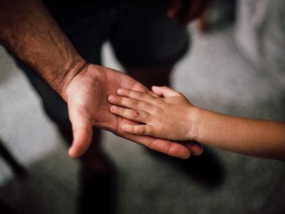Child and adult holding hand Child and adult holding hand